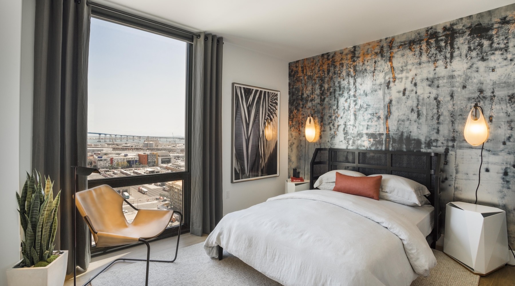 Sleep in style a bedroom with a chair, bed and large window