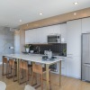 a kitchen with stainless steel appliances and wood-style flooring