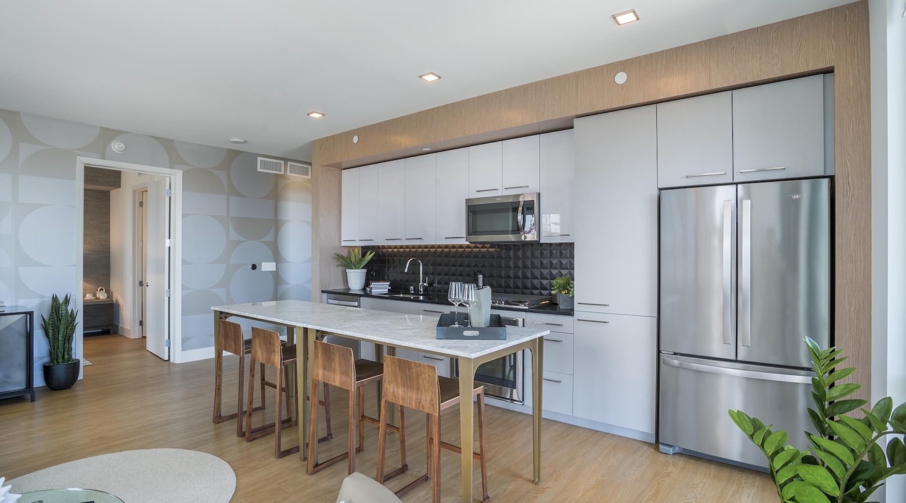 Beautiful kitchens with designer finishes a kitchen with stainless steel appliances and wood-style flooring