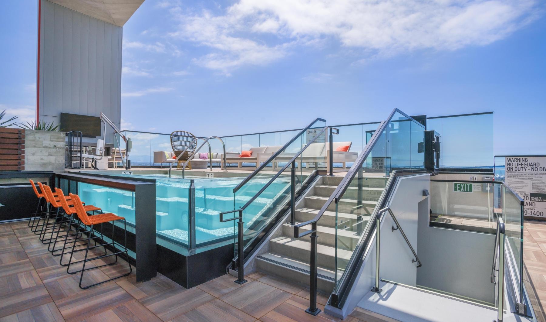 Relax and unwind poolside a large metal structure with a pool